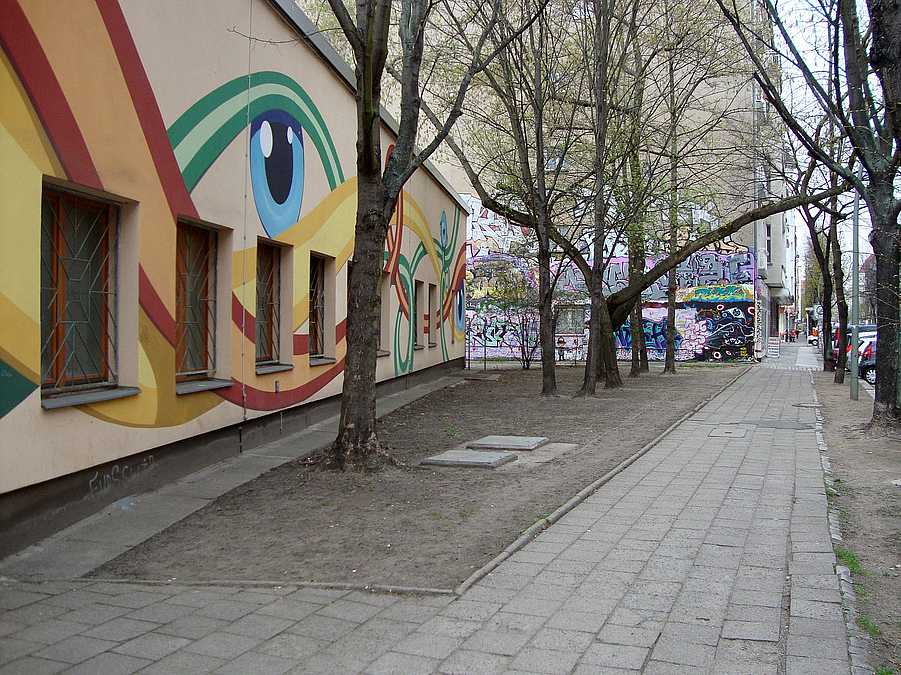 Fassade mit Wandbild an herbstlicher Straße