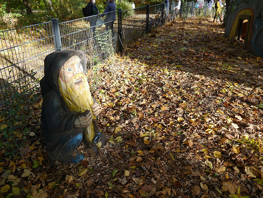 Holzfigur Zwerg auf Herbstboden